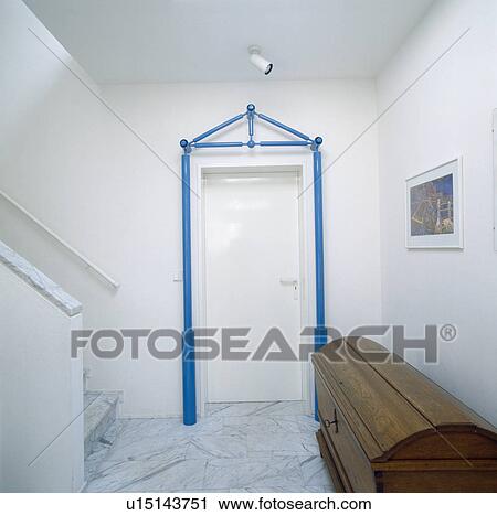 Antique wooden chest in modern white hall with blue metal frame around white door View Large Photo Image Stock Image - Antique wooden chest in modern white hall with blue metal frame around white door. Fotosearch