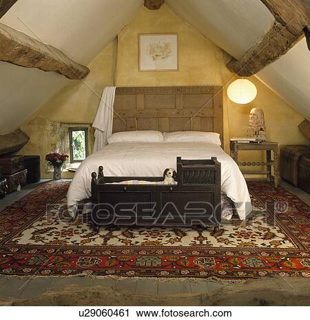 Antique wooden cradle below bed in attic bedroom with large patterned rug View Large Photo Image Stock Image - Antique wooden cradle below bed in attic bedroom with large patterned rug. Fotosearch