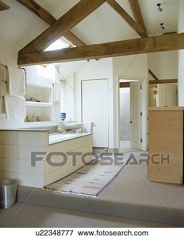 Beamed apex roof in modern white country bathroom View Large Photo Image Stock Photo - Beamed apex roof in modern white country bathroom. Fotosearch