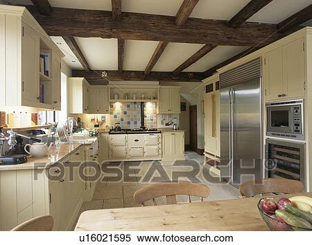 Beamed ceiling in large cream country kitchen View Large Photo Image Stock Photography - Beamed ceiling in large cream country kitchen. Fotosearch