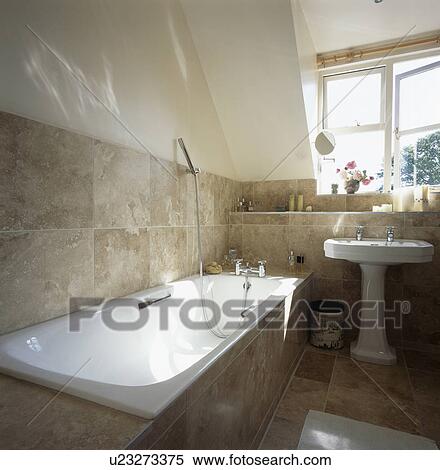 Beige tiled wall above bath in small white country bathroom View Large Photo Image Stock Photography - Beige tiled wall above bath in small white country bathroom . Fotosearch