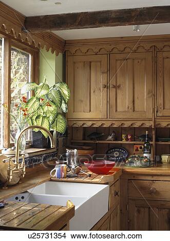Belfast sink in kitchen with fitted wooden cupboards View Large Photo Image Picture - Belfast sink in kitchen with fitted wooden cupboards. Fotosearch