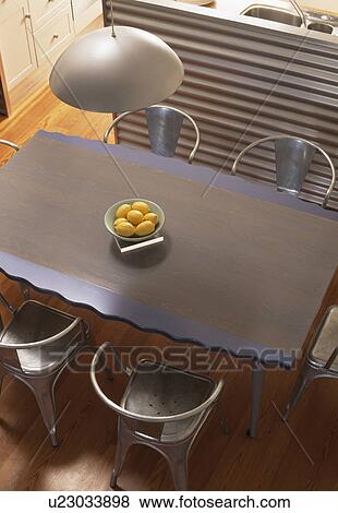 Birdseye view of metal table in modern loft conversion dining room View Large Photo Image Stock Photo - Birdseye view of metal table in modern loft conversion dining room. Fotosearch