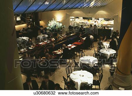 Stock Image - Birdseye view of tables in restaurant in London. Fotosearch