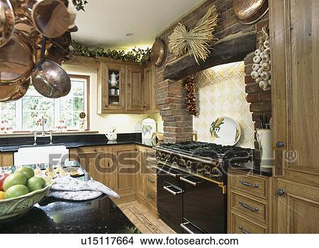 Black Aga oven in country kitchen with fitted oak units View Large Photo Image Picture - Black Aga oven in country kitchen with fitted oak units. Fotosearch
