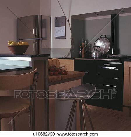 Stock Image - Black Aga oven in modern kitchen. Fotosearch
