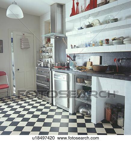 Black and white chequerboard flooring in modern kitchen with stainless steel oven and dishwasher View Large Photo Image Stock Image - Black and white chequerboard flooring in modern kitchen with stainless steel oven and dishwasher. Fotosearch