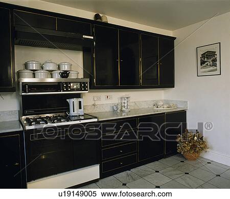 Black fitted units in modern white kitchen View Large Photo Image Stock Photography - Black fitted units in modern white kitchen. Fotosearch