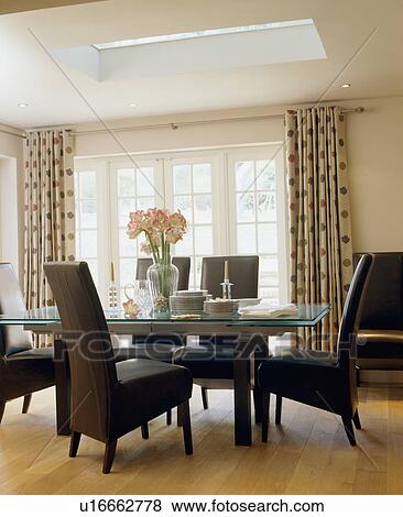 Black leather chairs and glass-topped table in modern dining room View Large Photo Image Stock Photo - Black leather chairs and glass-topped table in modern dining room. Fotosearch