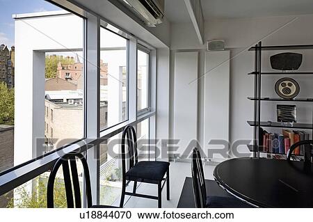 Black table and chairs in dining room in modern city apartment View Large Photo Image Stock Image - Black table and chairs in dining room in modern city apartment. Fotosearch