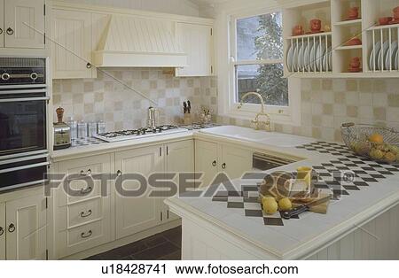 Black+white chequerboard tile insert in peninsular unit in kitchen with fitted white units View Large Photo Image Stock Image - Black+white chequerboard tile insert in peninsular unit in kitchen with fitted white units. Fotosearch