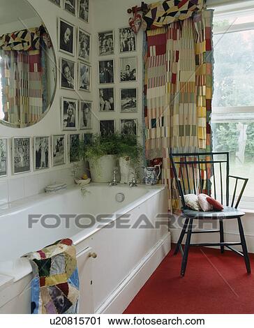 Black+white photograph collection above bath in bathroom with patchwork curtains View Large Photo Image Stock Image - Black+white photograph collection above bath in bathroom with patchwork curtains. Fotosearch