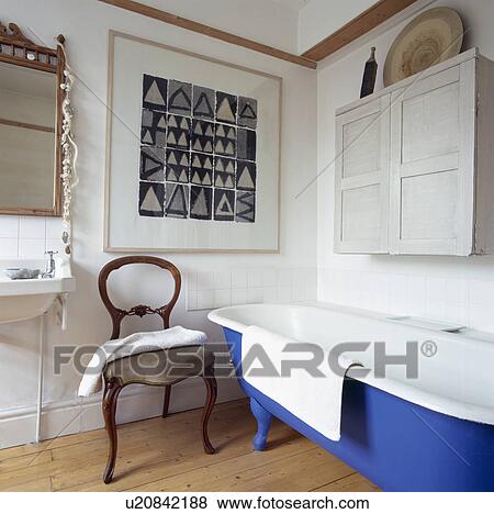 Black+white picture in small white bathroom with antique chair and rolltop bath View Large Photo Image Stock Photo - Black+white picture in small white bathroom with antique chair and rolltop bath. Fotosearch