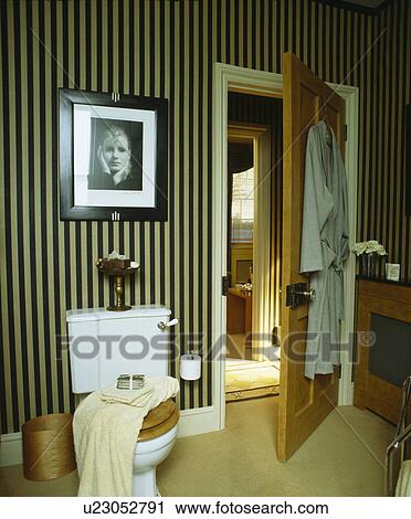 Black+white striped wallpaper in bathroom with large framed photograph above toilet View Large Photo Image Stock Image - Black+white striped wallpaper in bathroom with large framed photograph above toilet. Fotosearch