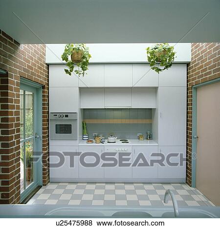 Blue chequerboard flooring and brick wall in modern kitchen View Large Photo Image Stock Photo - Blue chequerboard flooring and brick wall in modern kitchen. Fotosearch