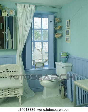 Stock Photo - Blue dado panelling in turquoise bathroom. Fotosearch