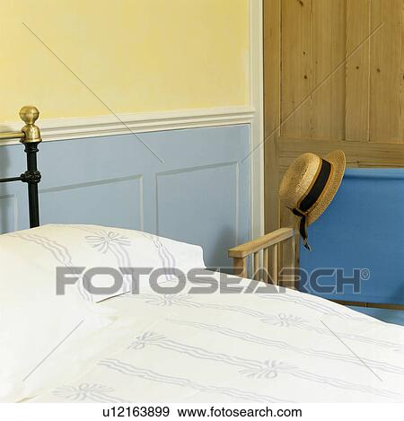 Stock Photo - Blue dado panelling on wall beside bed with blue+white bedlinen. Fotosearch