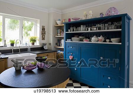 Blue Dresser With Marble Shelves In White Kitchen With Circular