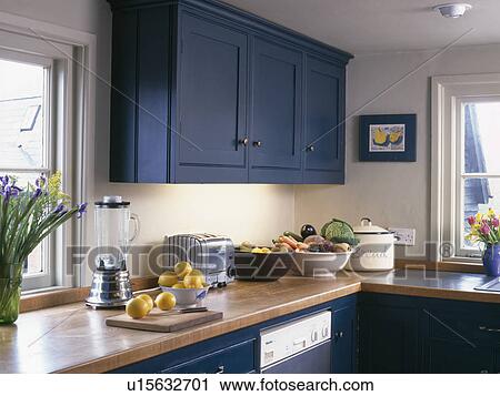Blue fitted cupboard above wooden worktop with electric blender and toaster View Large Photo Image Stock Image - Blue fitted cupboard above wooden worktop with electric blender and toaster. Fotosearch