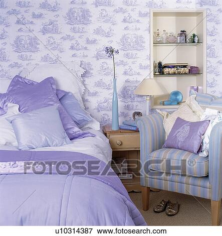 Blue silk cushions on bed in bedroom with blue+white Toile-de-Jouy wallpaper View Large Photo Image Stock Photo - Blue silk cushions on bed in bedroom with blue+white Toile-de-Jouy wallpaper. Fotosearch