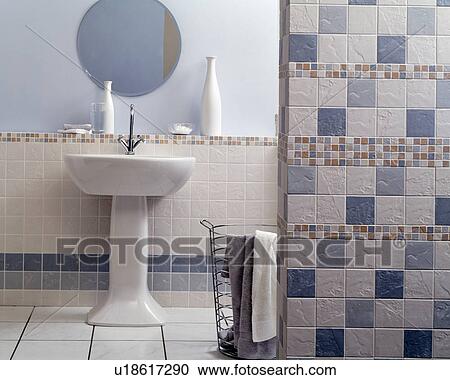 Blue+cream tiled wall in economy-style bathroom with white pedestal basin View Large Photo Image Stock Image - Blue+cream tiled wall in economy-style bathroom with white pedestal basin. Fotosearch