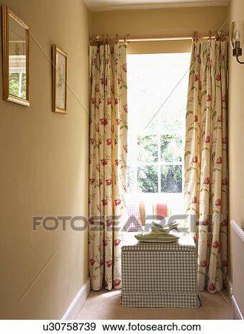 Blue+white check upholstered chest in front of window with floral curtains on cream landing View Large Photo Image Stock Photo - Blue+white check upholstered chest in front of window with floral curtains on cream landing. Fotosearch