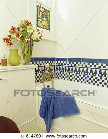 Blue+white chequerboard tiled border above bath in white bathroom View Large Photo Image Stock Image - Blue+white chequerboard tiled border above bath in white bathroom. Fotosearch