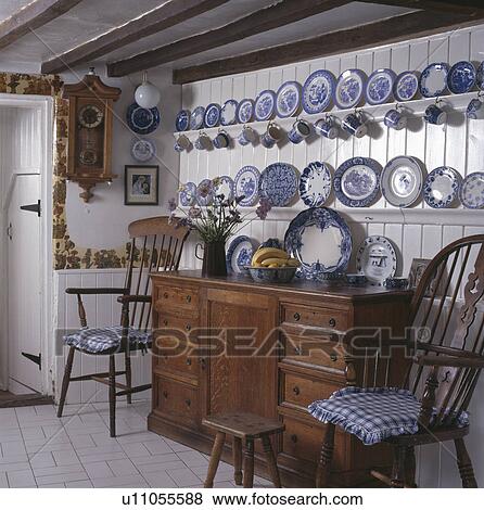 Blue+white china collection on shelves above antique cupboard View Large Photo Image Stock Photo - Blue+white china collection on shelves above antique cupboard. Fotosearch