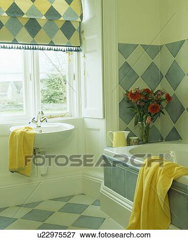 Blue+white diamond-checked blind above basin in bathroom with blue+white wall tiles View Large Photo Image Stock Photo - Blue+white diamond-checked blind above basin in bathroom with blue+white wall tiles. Fotosearch