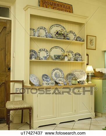 Stock Photo - Blue+white plates on cream dresser. Fotosearch