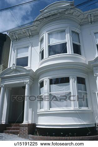 Stock Photography - Bow windows om traditional white semi-detached town-house. Fotosearch