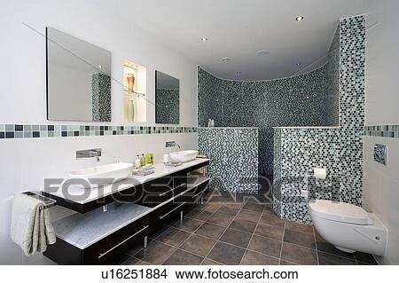 Bowl-style basins on marble-topped vanity unit in modern bathroom with curved glass mosaic walls on shower area View Large Photo Image Picture - Bowl-style basins on marble-topped vanity unit in modern bathroom with curved glass mosaic walls on shower area. Fotosearch