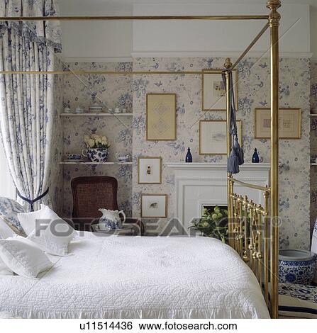 Brass bed in bedroom with blue+swhite floral curtains and wallpaper View Large Photo Image Stock Photograph - Brass bed in bedroom with blue+swhite floral curtains and wallpaper. Fotosearch