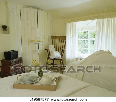 Breakfast tray on bed in cream country bedroom View Large Photo Image Stock Photo - Breakfast tray on bed in cream country bedroom. Fotosearch