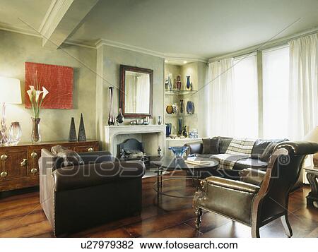 Stock Image - Brown leather armchair in comfortable modern living room. Fotosearch