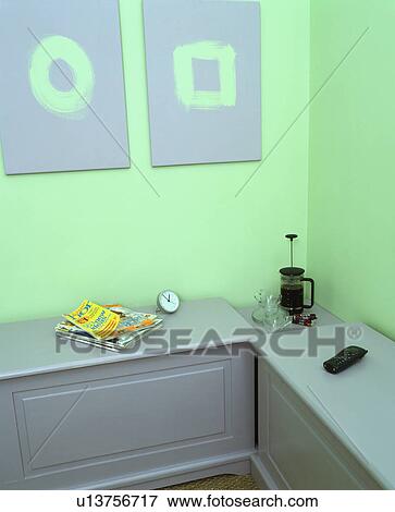 Cafetiere on grey storage chest in pastel green home office View Large Photo Image Stock Photo - Cafetiere on grey storage chest in pastel green home office. Fotosearch