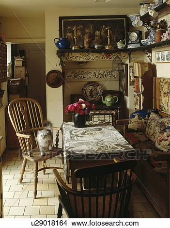 Cat on Windsor chair in country cottage kitchen View Large Photo Image Picture - Cat on Windsor chair in country cottage kitchen. Fotosearch
