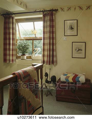 Checked curtains on window in landing with patchwork quilts on wooden chest and banisters View Large Photo Image Stock Image - Checked curtains on window in landing with patchwork quilts on wooden chest and banisters. Fotosearch