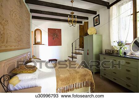 Chenille throw and white bedlinen on bed in Mediterranean bedroom with green wardrobe and chest-of-drawers View Large Photo Image Stock Image - Chenille throw and white bedlinen on bed in Mediterranean bedroom with green wardrobe and chest-of-drawers. Fotosearch