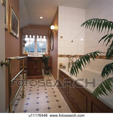 Stock Photo - Chequerboard vinyl flooring in narrow townhouse bathroom. Fotosearch