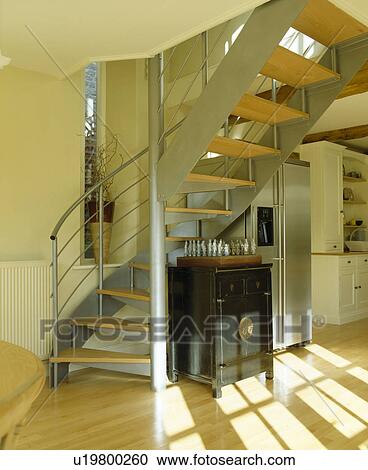 Chess set on cupboard below metal and wood spiral staircase in modern hall View Large Photo Image Stock Image - Chess set on cupboard below metal and wood spiral staircase in modern hall. Fotosearch