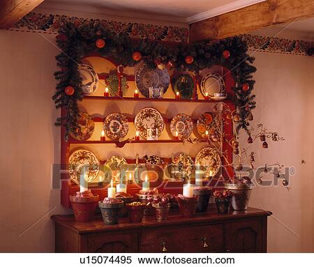 Christmas garland on shelves above sideboard with lighted candles View Large Photo Image Stock Photography - Christmas garland on shelves above sideboard with lighted candles. Fotosearch