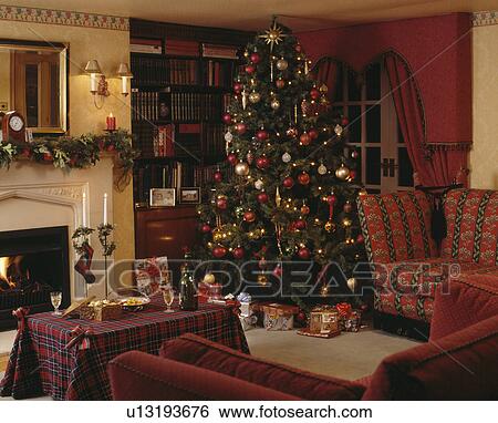Christmas tree in corner of traditional country living room View Large Photo Image Stock Photograph - Christmas tree in corner of traditional country living room. Fotosearch