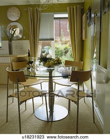 Circular glass table and laminated wood chairs in modern dining room View Large Photo Image Stock Image - Circular glass table and laminated wood chairs in modern dining room. Fotosearch