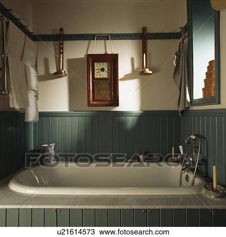 Clock and candlesticks on pegrail above bath in turquoise panelled Shaker bathroom View Large Photo Image Stock Image - Clock and candlesticks on pegrail above bath in turquoise panelled Shaker bathroom. Fotosearch