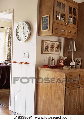 Clock on wall in traditional kitchen with fitted wooden cupboards View Large Photo Image Stock Image - Clock on wall in traditional kitchen with fitted wooden cupboards. Fotosearch