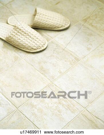 Close-up of beige slippers on beige tiled floor View Large Photo Image Stock Image - Close-up of beige slippers on beige tiled floor. Fotosearch