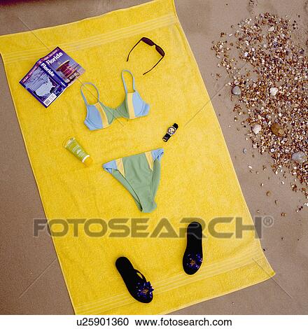 Close-up of bikini with book and flip-flops on yellow beach-towel View Large Photo Image Stock Image - Close-up of bikini with book and flip-flops on yellow beach-towel. Fotosearch