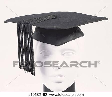 Stock Image - Close-up of black mortar-board on white plastic head. Fotosearch