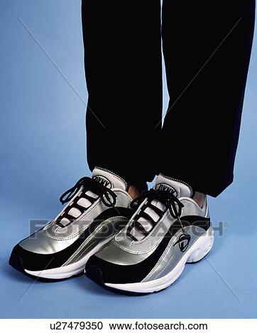 Close-up of black+grey trainers worn by person View Large Photo Image Stock Image - Close-up of black+grey trainers worn by person. Fotosearch